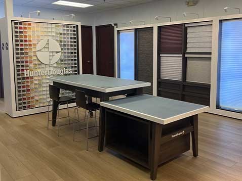 Store interior showcasing several different types of window coverings